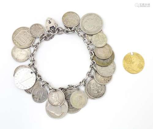 A silver and white metal bracelet set with various coin form...