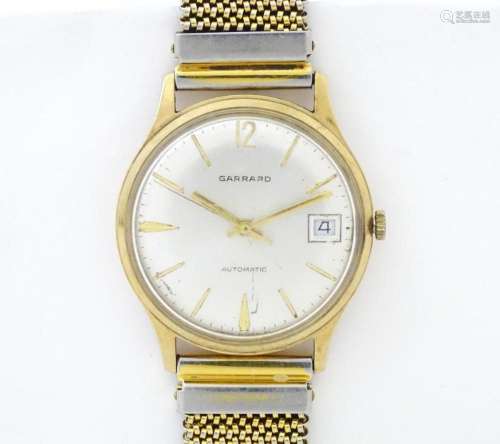 A 9ct gold cased Garrard Automatic wristwatch, the dial with...