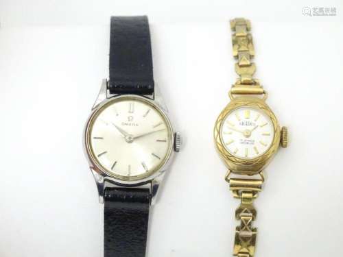 A ladies Omega wind wristwatch together with a 9ct gold case...