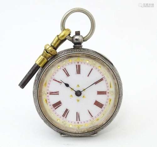 A Continental .935 silver fob watch with engraved decoration...