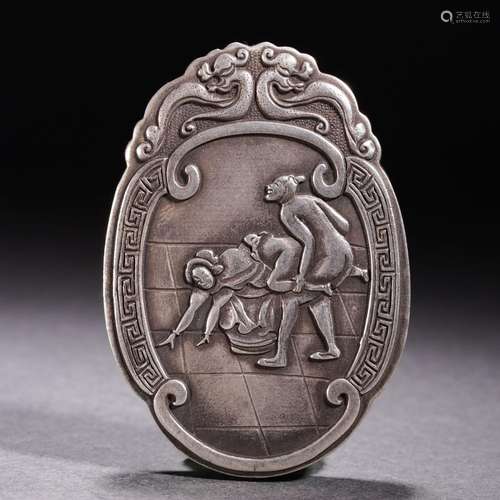 A silver erotic pendant