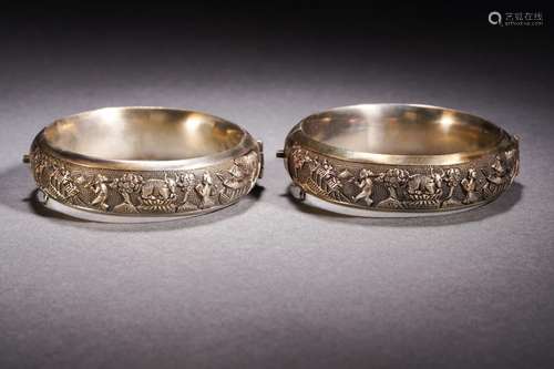 A Pair of silver high-relief figure bracelets