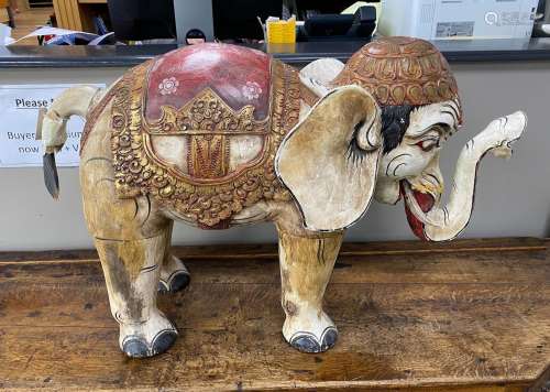 A large Indonesian painted wood model of an elephant, length...