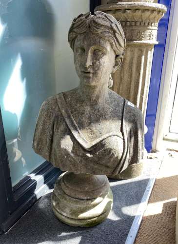 A reconstituted stone female bust on shallow plinth, height ...