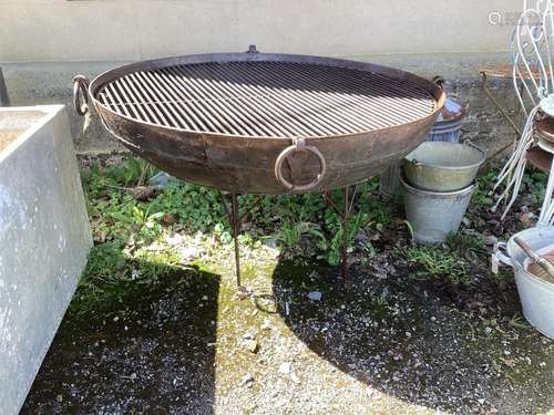 A large circular wrought and cast iron fire pit on stand dia...