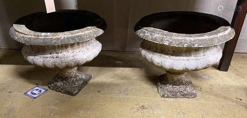 A pair of circular reconstituted stone campana garden urns, ...