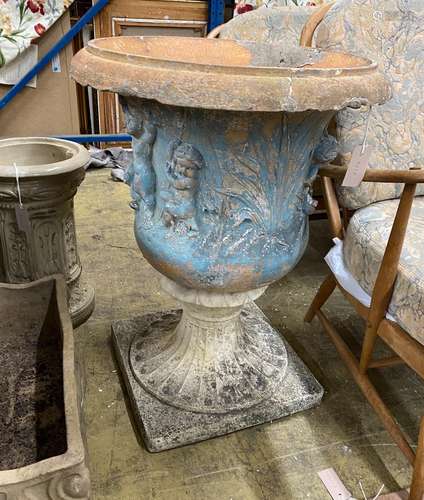 A reconstituted stone campana garden urn on a later composit...