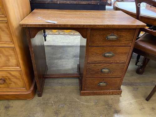 A small 1920s oak four drawer kneehole desk, length 81cm, de...