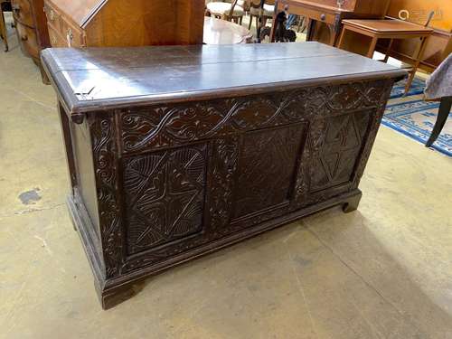 An 18th century and later carved oak coffer, with zinc liner...