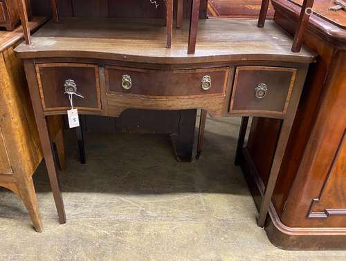 An Edwardian satinwood banded mahogany serpentine side table...