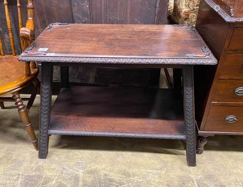 An early 20th century Continental carved hardwood two tier t...