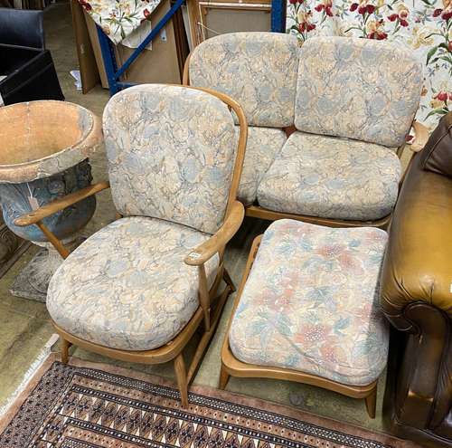 An Ercol elm three piece suite comprising settee, armchair a...