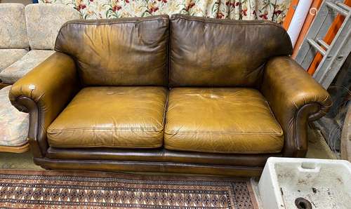 A Thomas Lloyd tan leather two seater sofa, length 190cm, de...