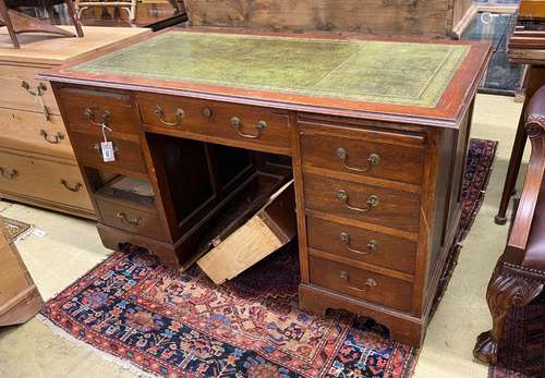 An early 20th century oak kneehole desk, length 141cm, depth...