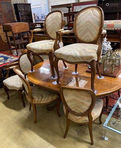 A Queen Anne Revival oval walnut extending dining table, len...