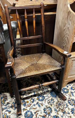 An early 19th century ash rush seat spindle back rocking cha...