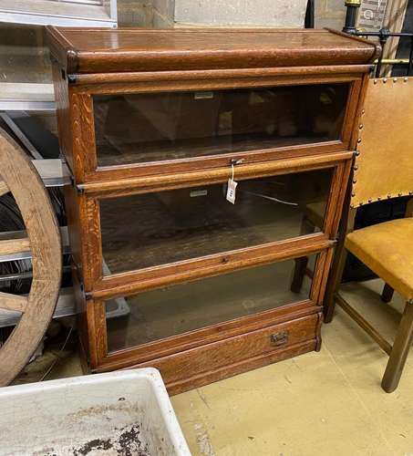 A Globe Wernicke oak three section bookcase with base drawer...