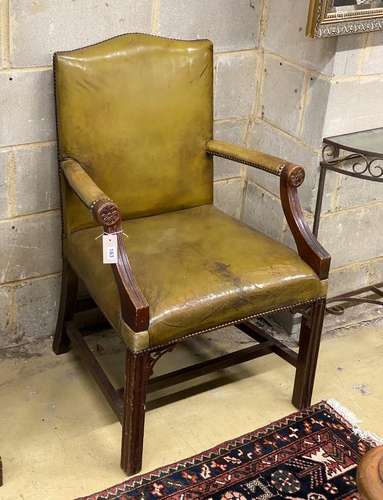 A George III style mahogany green leather library armchair, ...