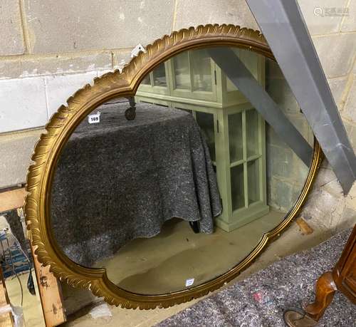 A large quatrelobed carved giltwood wall mirror, width 140cm...