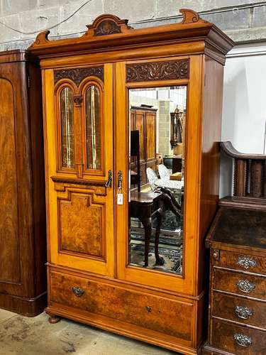 A late Victorian satin walnut and burr elm two door mirrored...