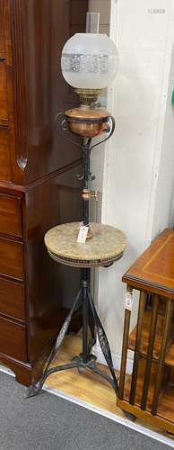 An Edwardian wrought iron and copper telescopic standard lam...