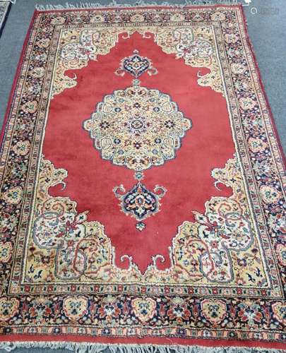 A Belgian machined red ground rug, in Kerman style, 190 x 13...