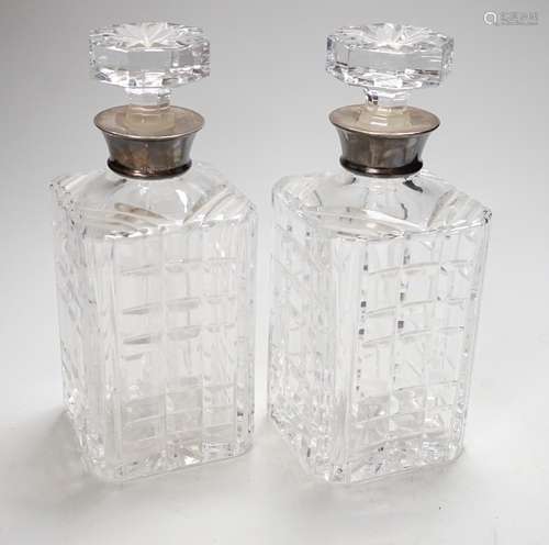 A pair of 20th century silver collared glass decanters and s...