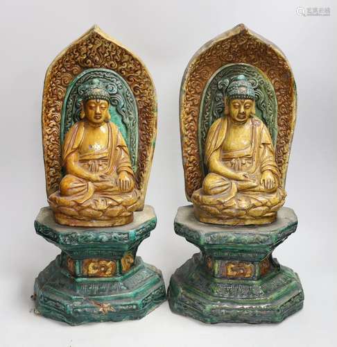 A pair of Chinese sancai glazed Buddha figures on shrines. 4...