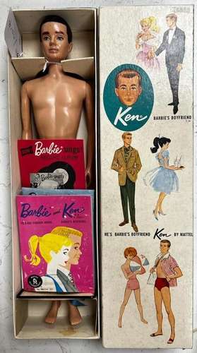 A boxed Ken doll, with another box of Ken clothing