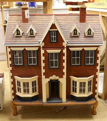 A mid 20th century dolls house and contents, 84cms x 100cms ...