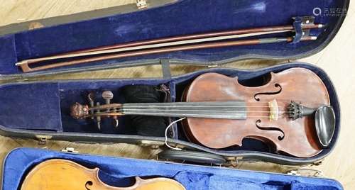 A violin with carved lion head scroll and two bows in one ca...