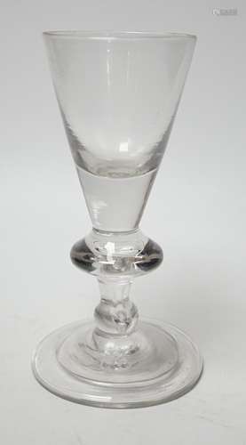 A George I heavy baluster wine glass, round funnel bowl abov...