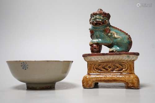 A 19th century Chinese Shiwan figure of a lion-dog and celad...