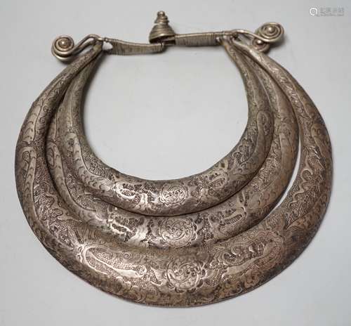 A Chinese Miao white metal triple necklace, repousse worked ...