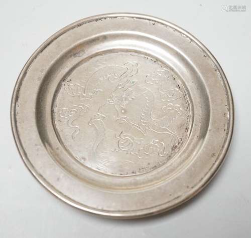 A Chinese white metal small dish, engraved with dragon, diam...