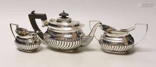 An Edwardian three piece demi-fluted silver tea set, Birming...