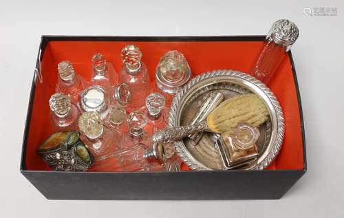 A collection of assorted silver mounted glass scent bottles ...