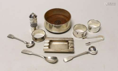 A silver coaster, ashtray, two napkin rings, cutlery etc.