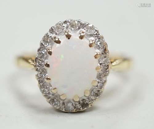 A modern 18ct white gold white opal and diamond set oval clu...