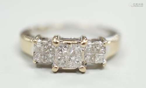 A modern 18ct white gold and triple princess cut diamond clu...