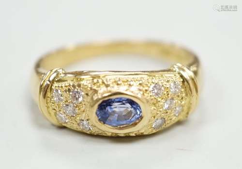 A modern 18ct gold, single stone oval cut sapphire and ten s...