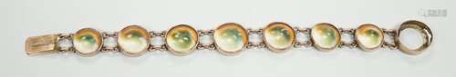 An early 20th century yellow metal and shell set bracelet (c...