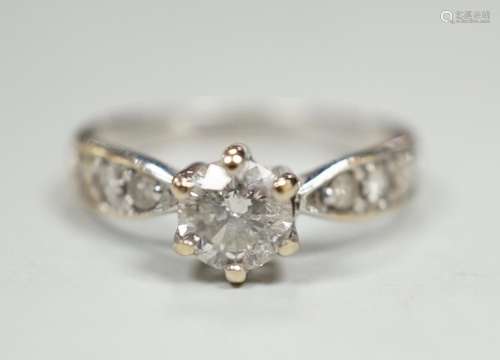 A modern 18ct gold and single stone diamond ring, with diamo...