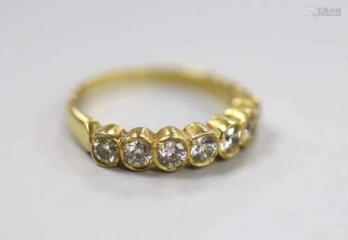 A modern 750 yellow metal and seven stone diamond set half h...