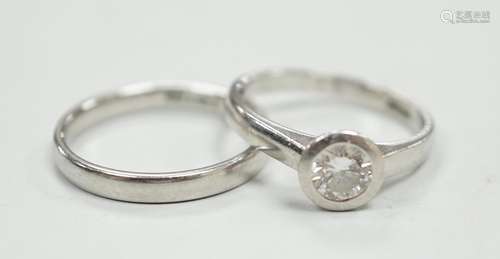 A modern platinum and collet set solitaire diamond ring, siz...