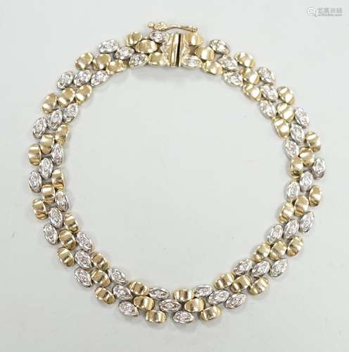 A modern two colour 585 and diamond chip set bracelet, 18cm,...