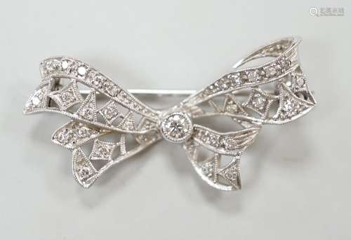 A white metal and diamond cluster set ribbon bow brooch, 36m...