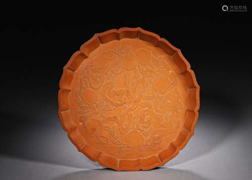 A flower shaped peach patterned bamboo plate