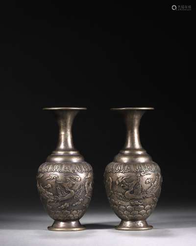 A pair of phoenix bird patterned silver vases
