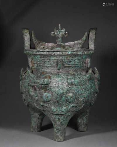 A taotie patterned bronze pot with a lid
